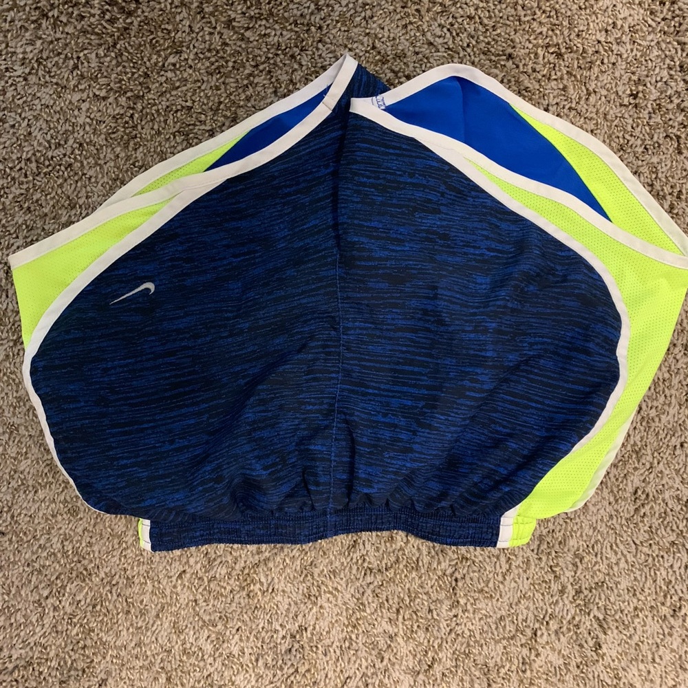 blue and neon yellow Nike running shorts